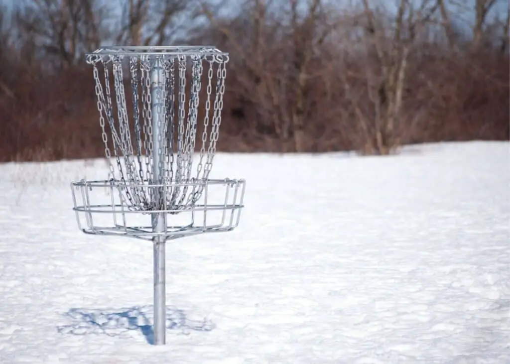 disc golf basket in the winter snow