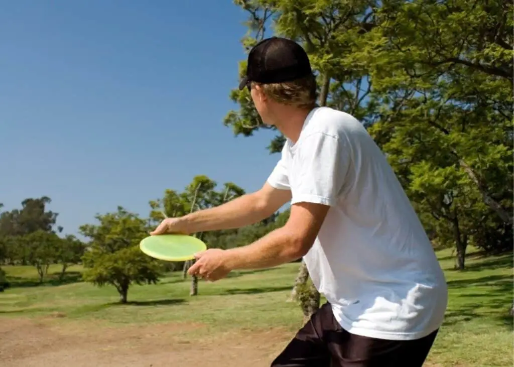 man throwing a disc golf disc
