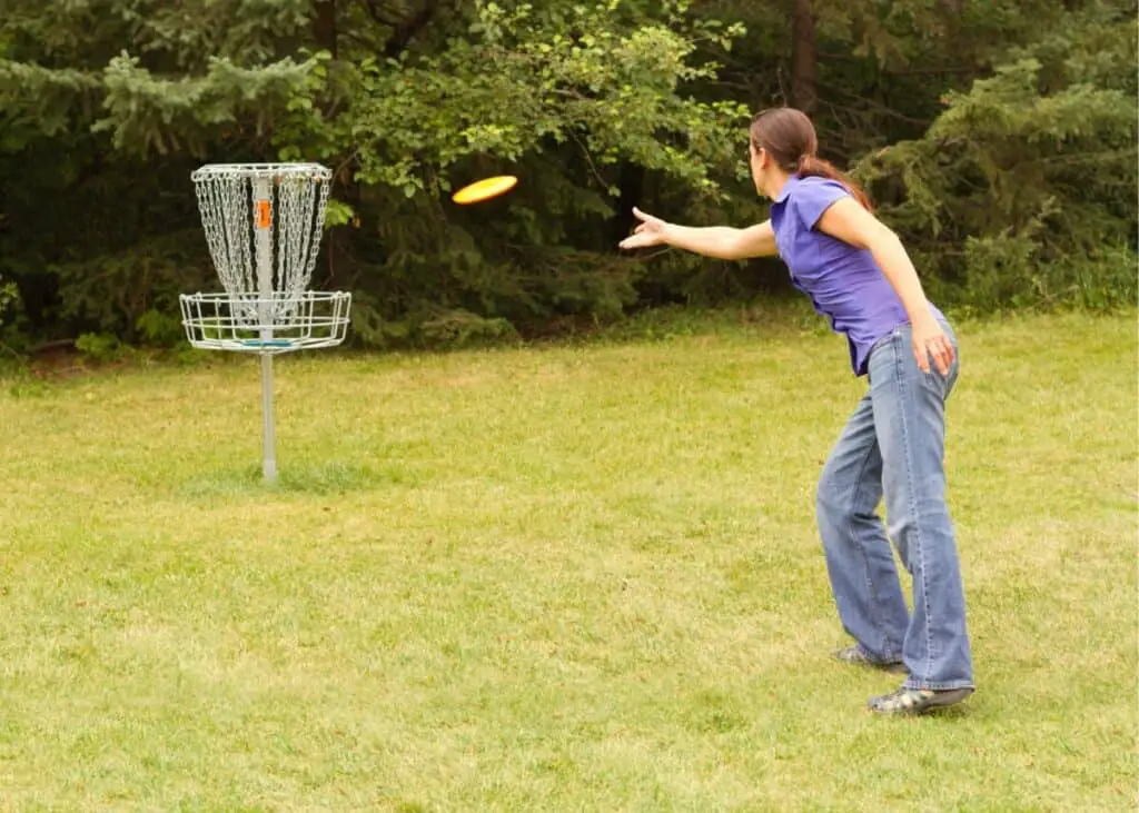 Woman throwing a disc from inside the circle.